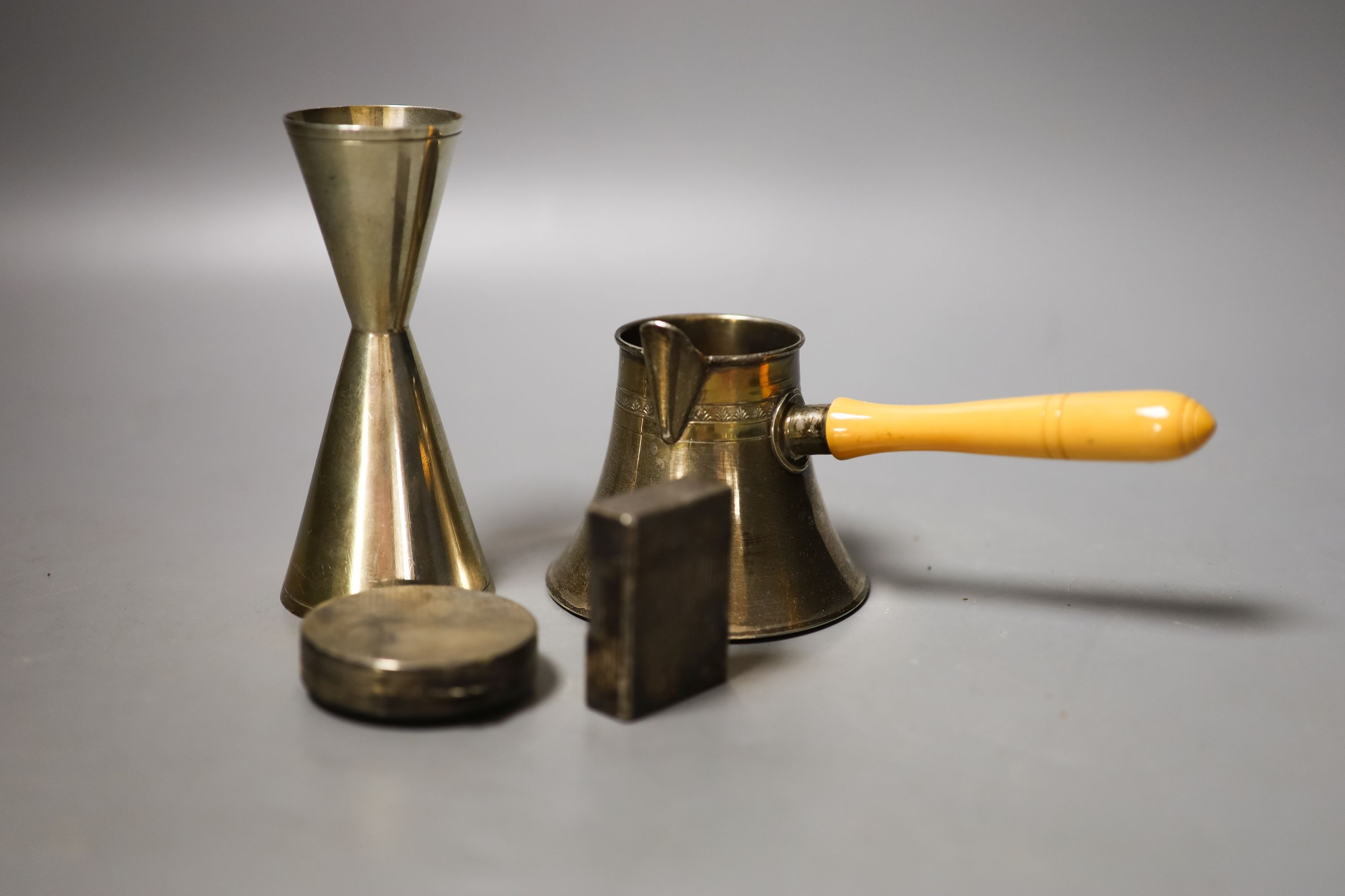 A 20th century Egyptian white metal brandy pan, a plated Dupont lighter, double measure and compact.